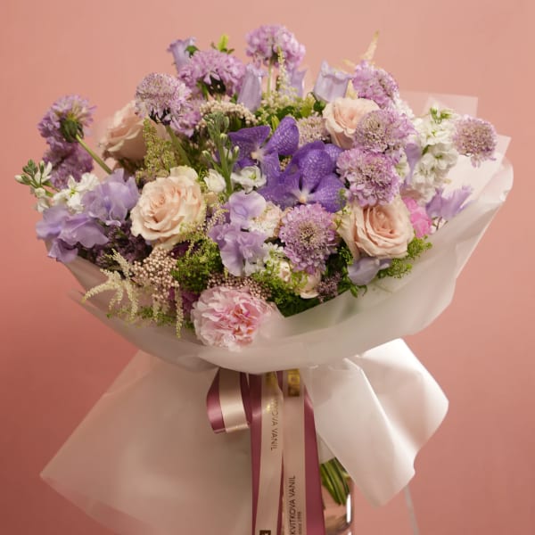 Lavender and blush bouquet wrapped in white paper