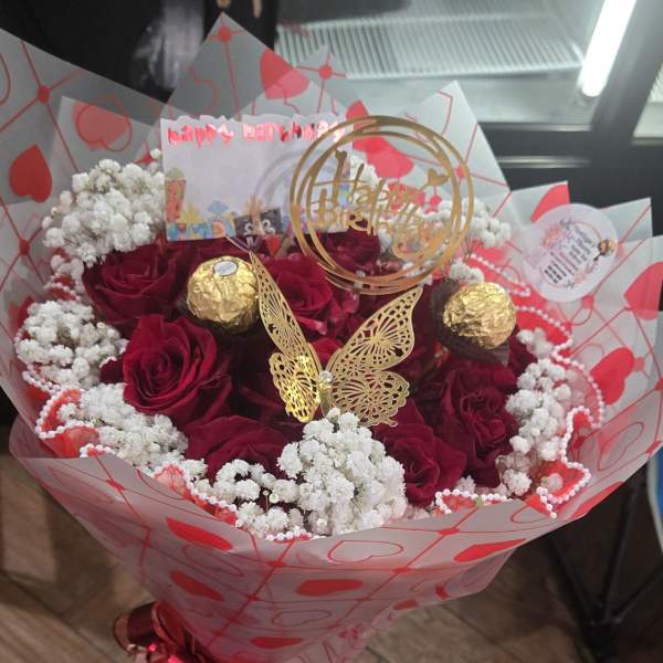 Bouquet of red roses with white baby's breath and gold decorations