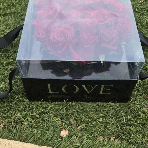 Boxed bouquet of pink roses in a clear lid gift box