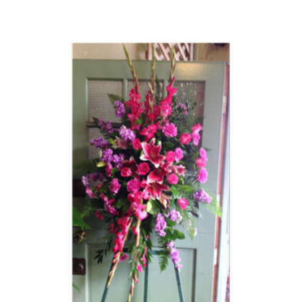 Tall pink and purple floral standing spray on an easel