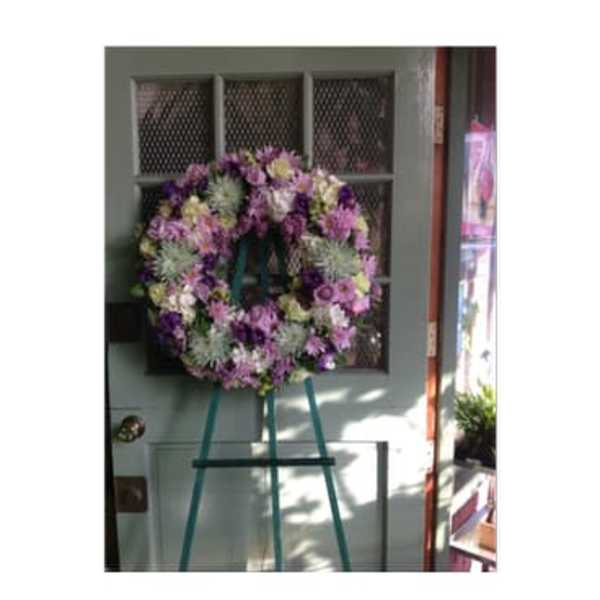 Purple and pink floral wreath on a standing easel