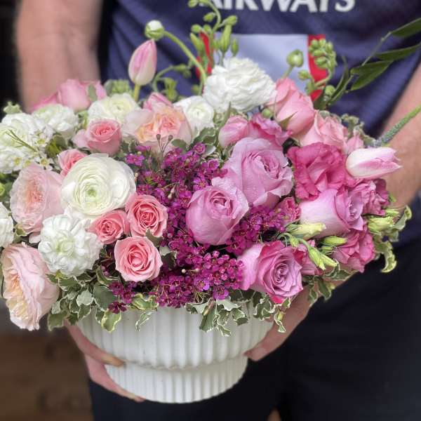 Pink and white rose bouquet in a white ribbed vase