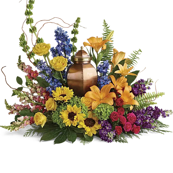 Colorful floral arrangement around a copper urn