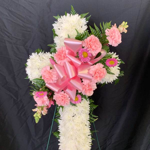 Pink and white floral standing spray with a large pink ribbon