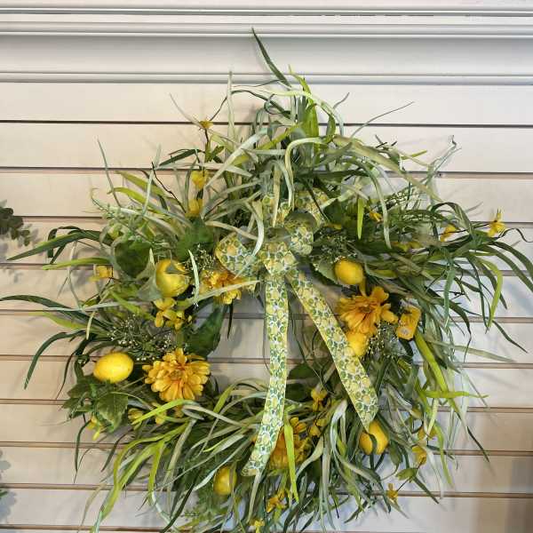 Yellow floral wreath with ribbon and lemon accents