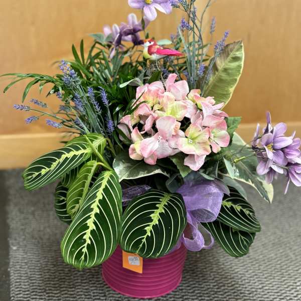 Pink and lavender floral arrangement in a magenta pot
