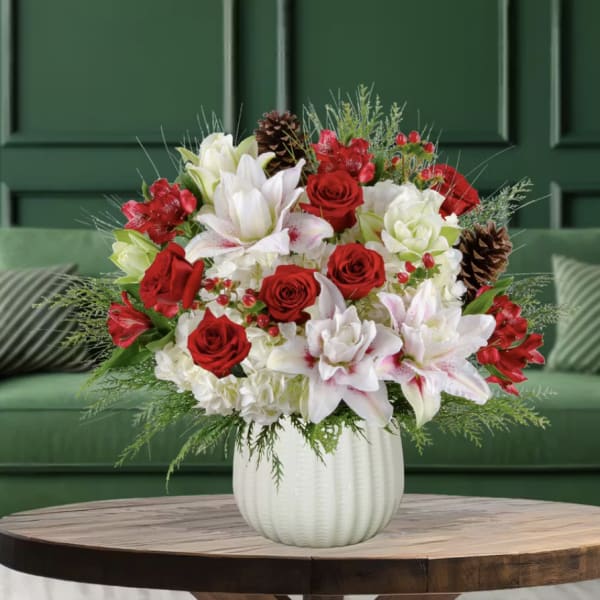Red roses and white lilies in a white vase