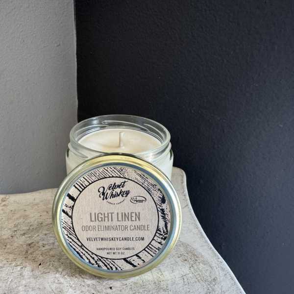 Glass jar candle with a labeled lid on a tabletop