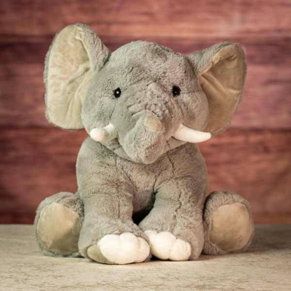Plush gray elephant toy with white tusks and feet