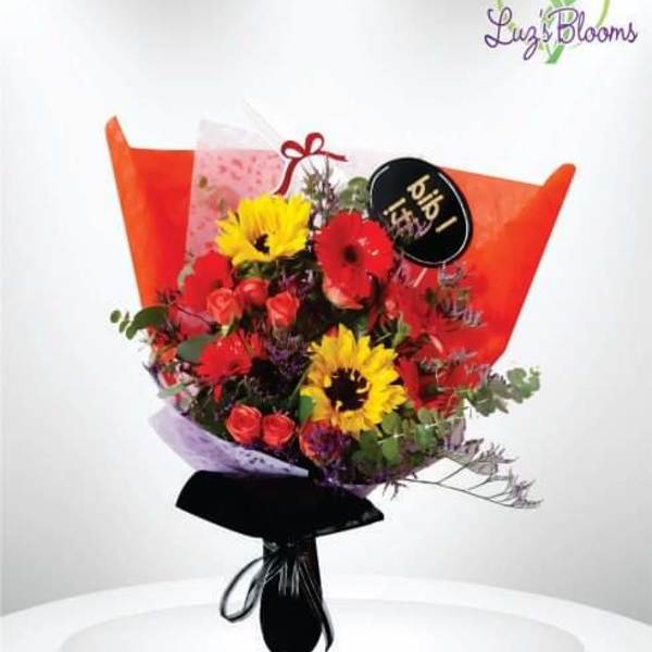 Bouquet of red and yellow flowers wrapped in orange paper