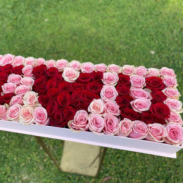 Rectangular box arrangement of red and pink roses
