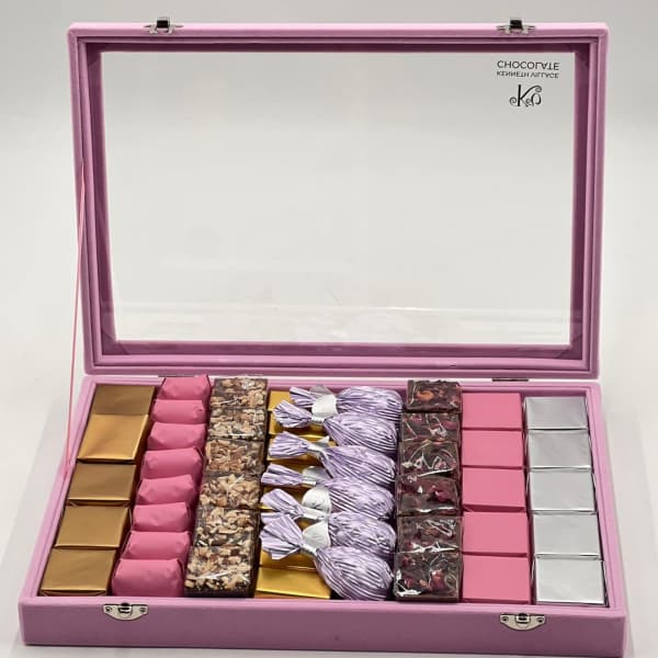 Pink gift box with assorted wrapped chocolates and candies