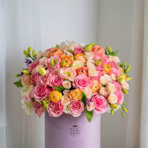 Pink and peach rose bouquet in a lavender hat box