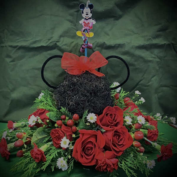 Mickey Mouse-themed floral arrangement with red roses and daisies