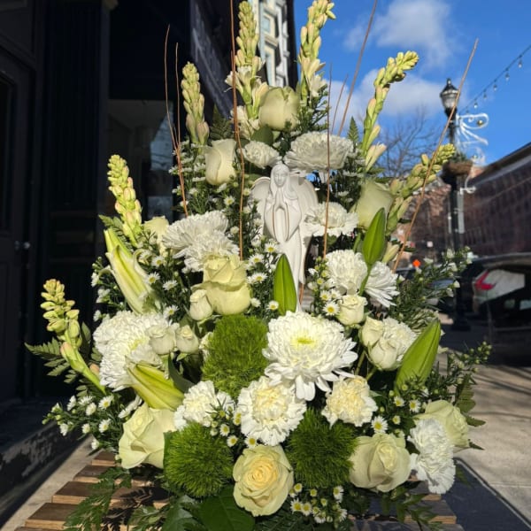 Tall white floral arrangement with roses, lilies, and chrysanthemums