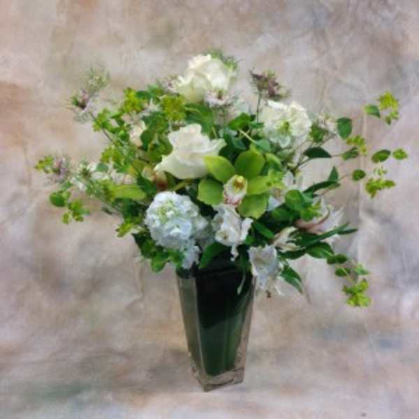 White floral arrangement in a tall clear vase