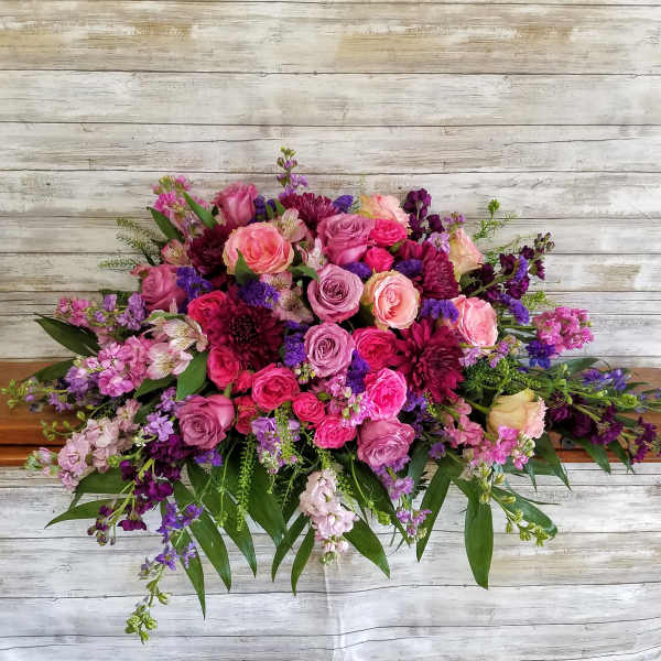Large bouquet of pink and purple roses with mixed blooms