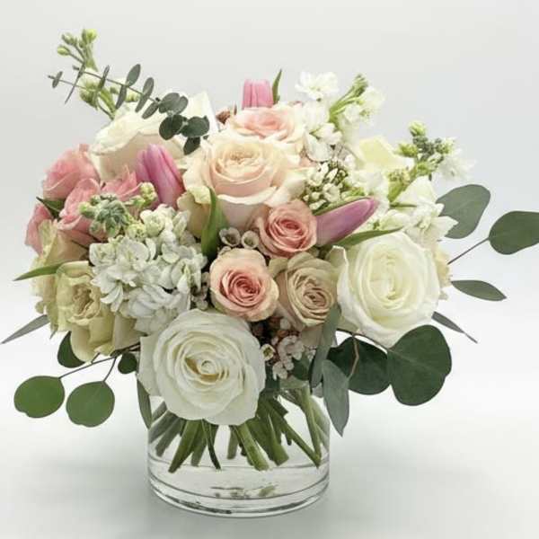 Pink and white rose bouquet in a clear glass vase