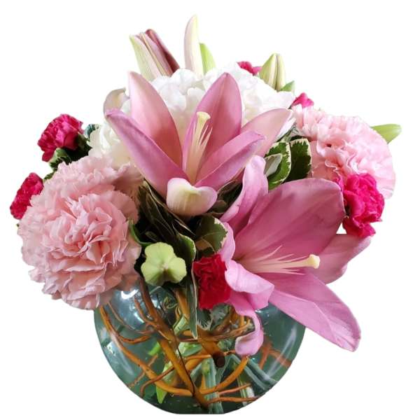 Pink lilies and carnations arranged in a glass vase