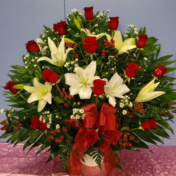 Large bouquet of red roses and white lilies with a red ribbon
