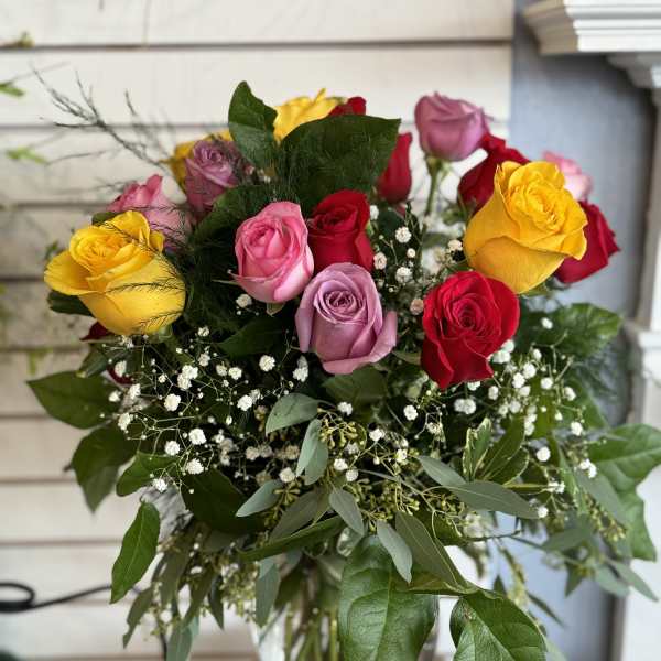 Bouquet of multicolored roses in a glass vase