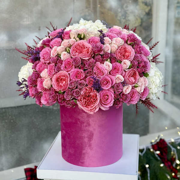 Pink and white rose arrangement in a tall magenta box