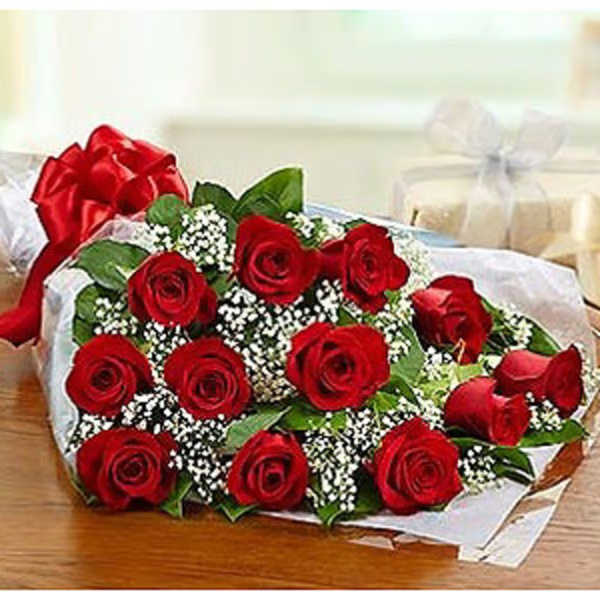 Bouquet of red roses with baby's breath wrapped in white paper