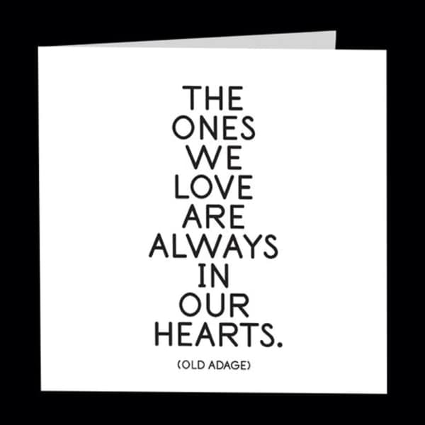 White sympathy card with the words "The ones we love are always in our hearts."
