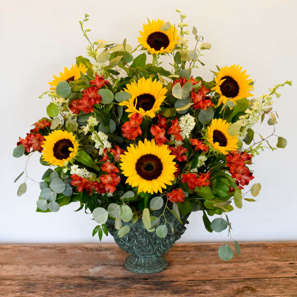 Sunflower and red alstroemeria arrangement in a decorative vase