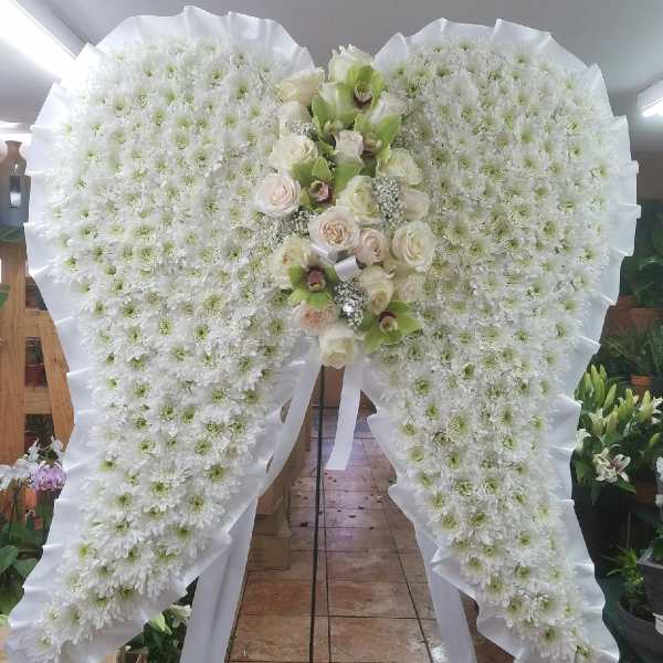 Large white floral standing spray with roses and orchids