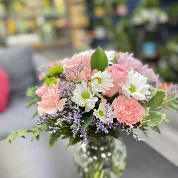 Pink and white mixed bouquet in a clear glass vase