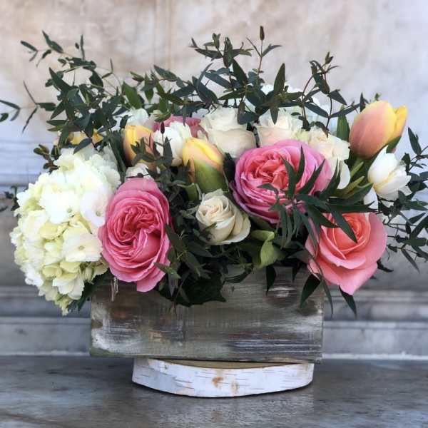 Pink and white roses with hydrangea in a rustic wooden box