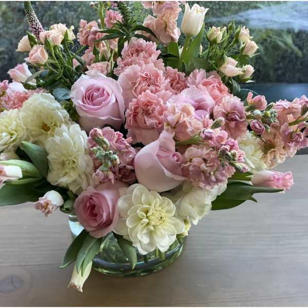 Pink and white floral arrangement in a glass vase