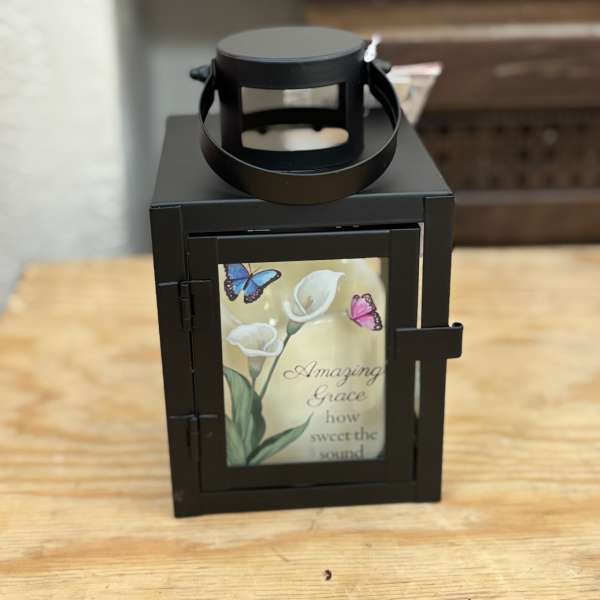 Black lantern with a floral memorial-style insert and butterflies