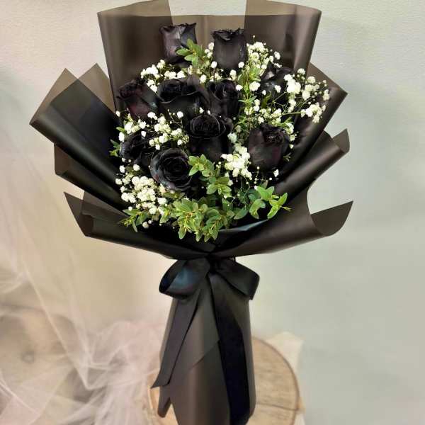 Bouquet of black roses with white baby's breath in black wrap