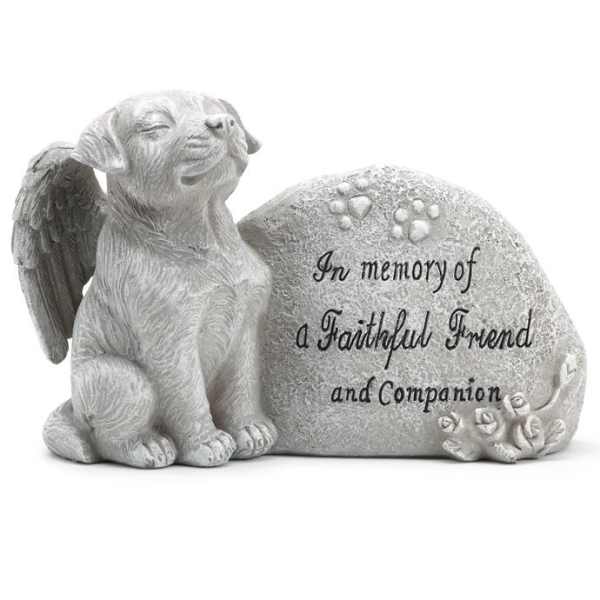 Memorial stone with a sleeping dog and engraved tribute text