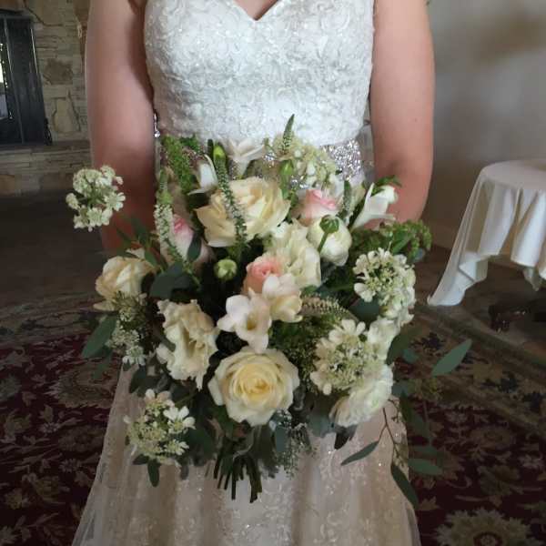 Bride holding a white and blush wedding bouquet