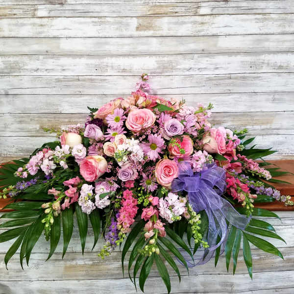 Large pink and lavender floral spray with a purple ribbon