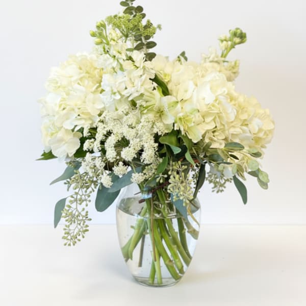 White hydrangea bouquet in a clear glass vase