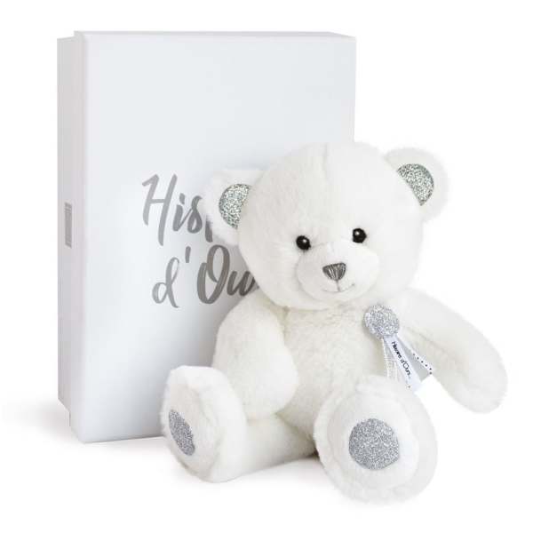 White teddy bear with silver accents beside a white gift box