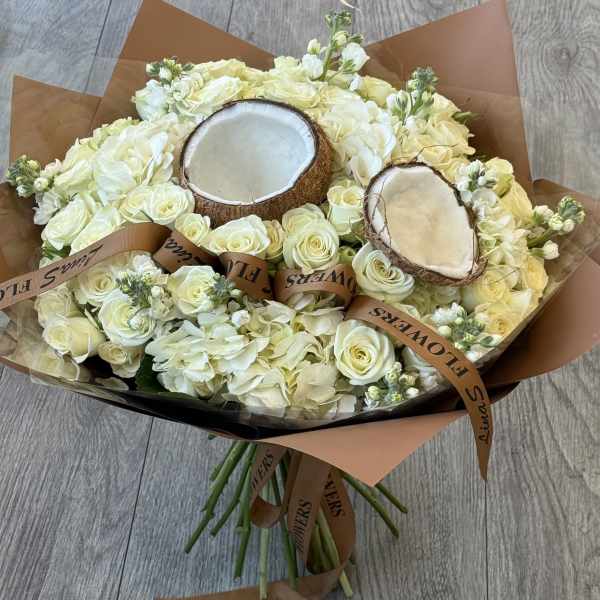 Bouquet of white roses and hydrangeas with two coconut halves