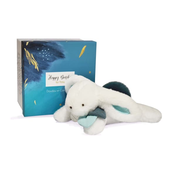 White plush bunny toy beside a blue gift box