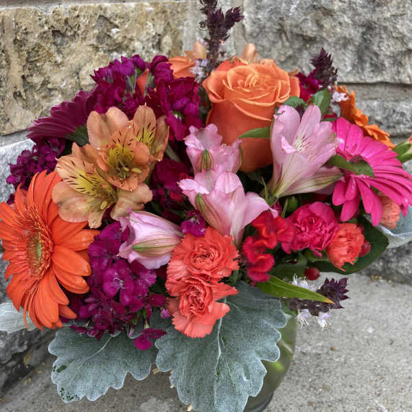 Bright mixed bouquet with orange roses, gerbera daisies, and pink flowers