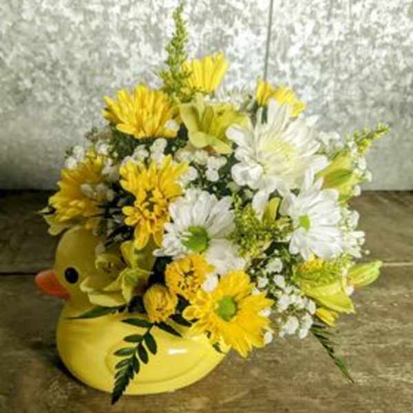 Yellow and white daisy bouquet in a yellow duck container
