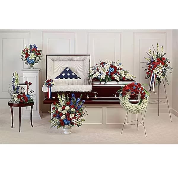 Sympathy casket with patriotic red, white, and blue floral sprays