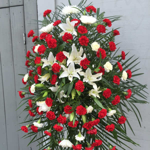 Standing floral spray with red carnations and white lilies