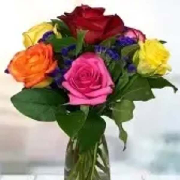 Bouquet of multicolored roses in a clear glass vase