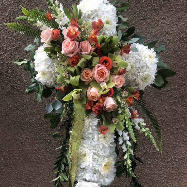 Standing floral spray with white chrysanthemums, pink roses, and orange accents