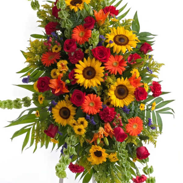 Tall standing spray of sunflowers, roses, and orange blooms