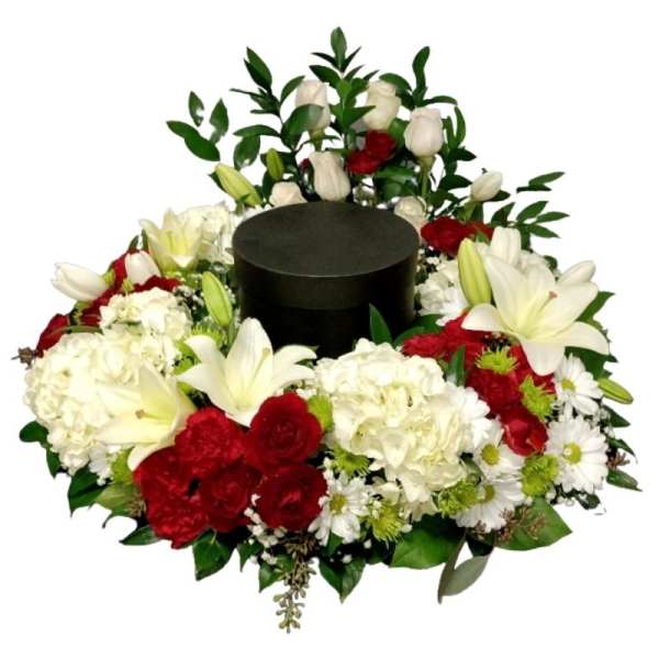 Floral wreath with red and white flowers around a black hat box